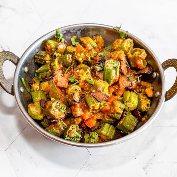 Delhi Diner's Bhindi Masala, a vibrant Indian dish of okra in a rich tomato-based sauce.