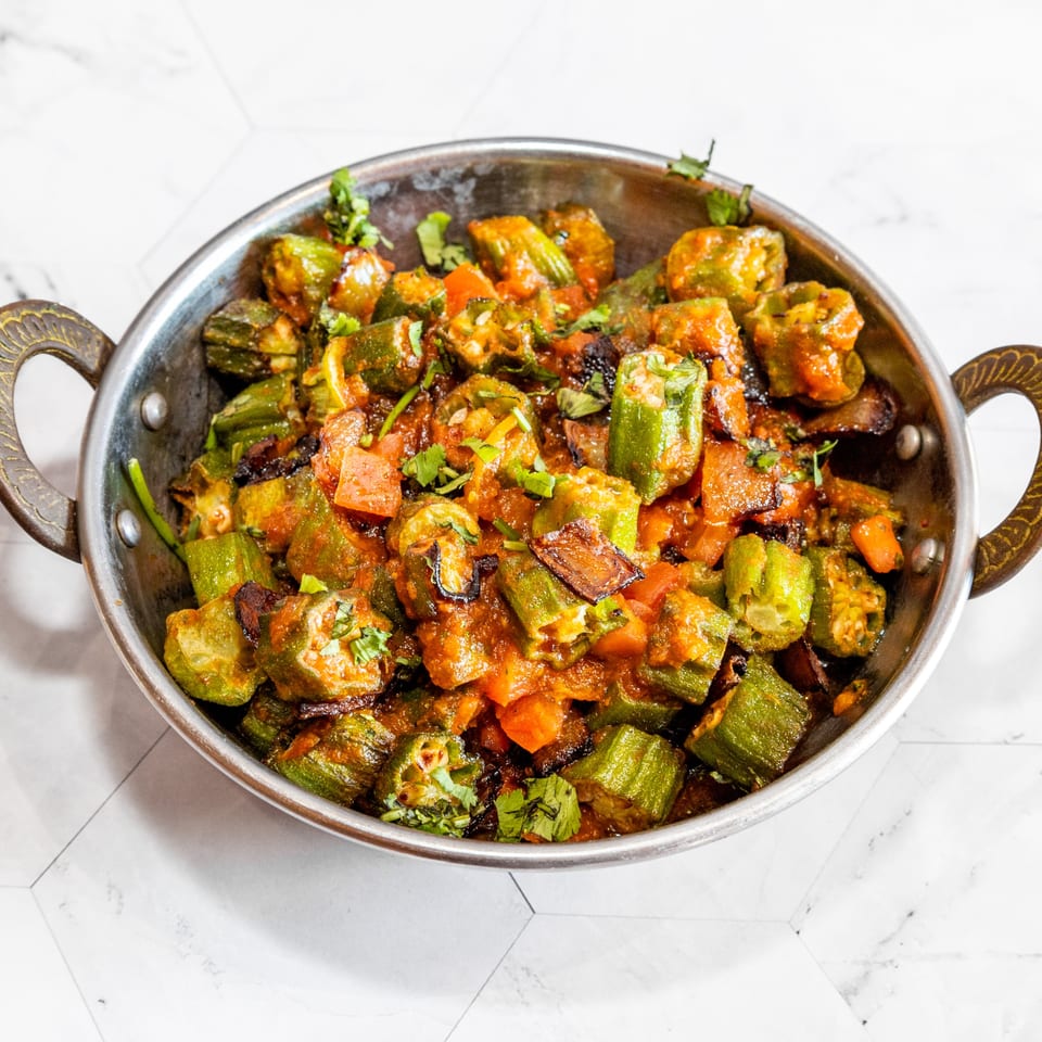 Delhi Diner's Bhindi Masala, a vibrant Indian dish of okra in a rich tomato-based sauce.
